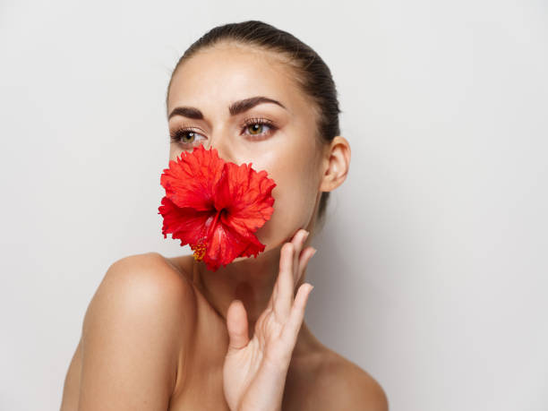 istock pretty woman flower face bare shoulders clear skin studio 2191911683