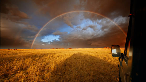 Safari Vehicle Under Rainbow in Masai Mara
