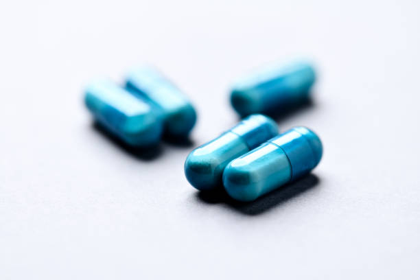 Amino acids capsules on paper background. Soft focus. Close up.