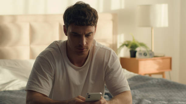 istock Angry irritated Caucasian man throw mobile phone smartphone on bed male guy error failure technology problem trouble annoyed bad news bankruptcy furious negative emotions loss bedroom touching face 2191914352