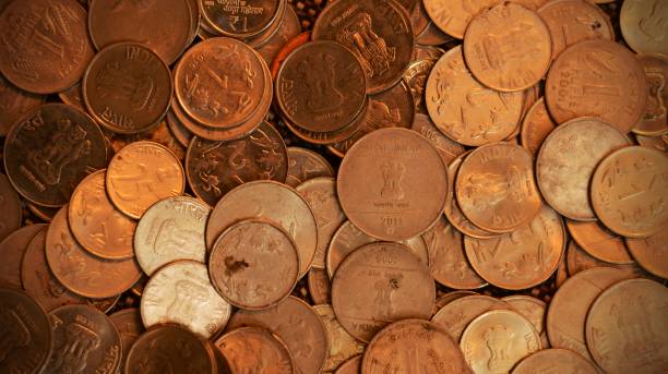 istock Horizontal click of scattered Indian currency coins spread or scattered randomly all over with slight deliberate grains 2191914465