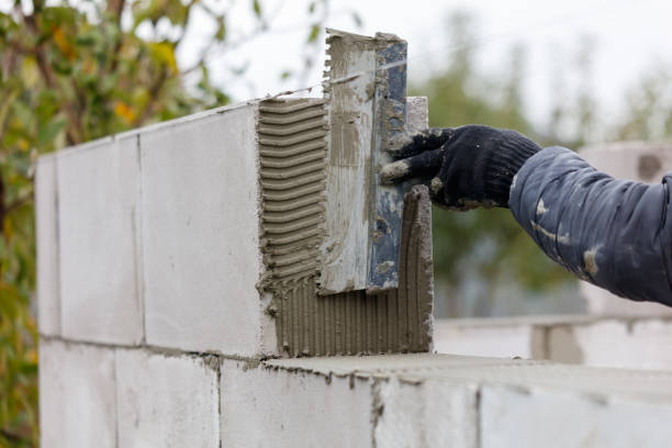 istock A person is using a trowel to apply mortar to a brick wall 2191917323