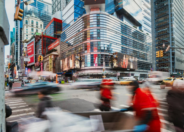 istock motion blurred people crosssing avenue in manhattan 2191918395