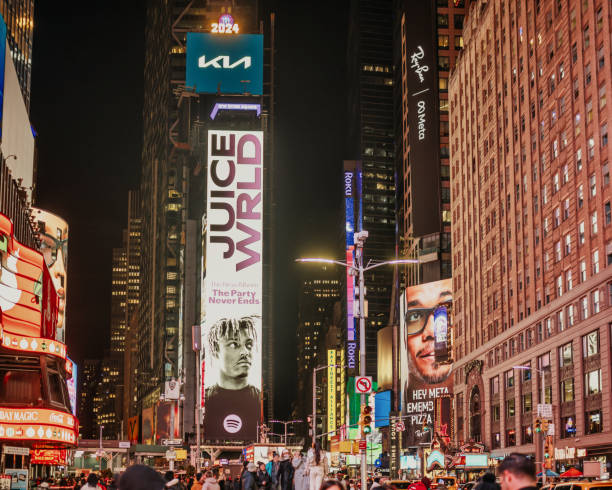 illuminated billboards and screens at crowded times square in manhattan - new york at night