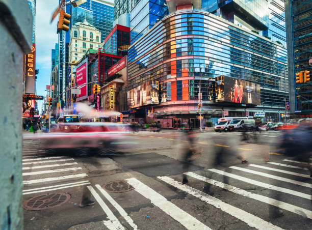 istock motion blurred people crosssing avenue in manhattan 2191918471