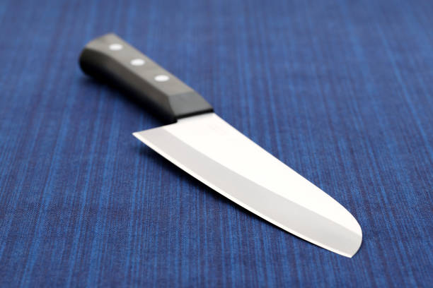 Knife on a white background. Kitchen knife with a wooden handle. Wooden knife