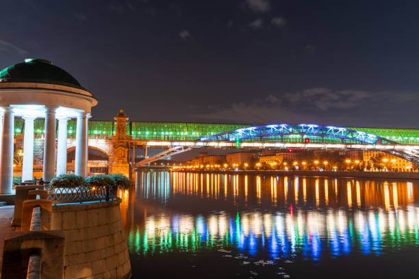 Pushkinskiy bridge with night illumination. Pedestrian bridge with night illumination. Bridge to Gorky Park. Embankment of the Moscow River