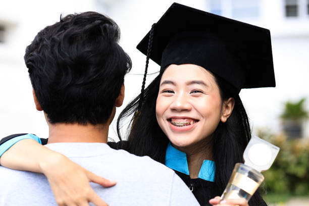 istock Happy Female Graduate Student Holding Diploma in Her Hand and Smile While Hugging Her Boyfriend 2191923014