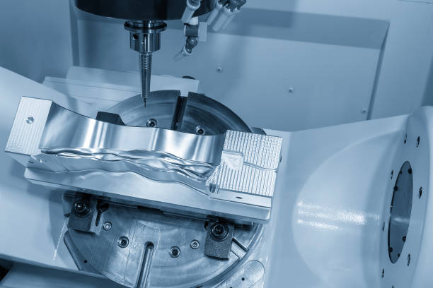 istock The 5-axis CNC milling machine  cutting the automotive part with solid ball end mill tool in the light blue scene. 2191924485