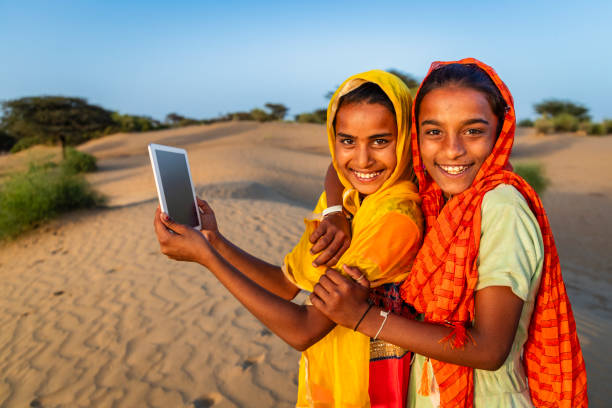 istock Happy Gypsy Indian girls using a digital tablet, India 2191924812