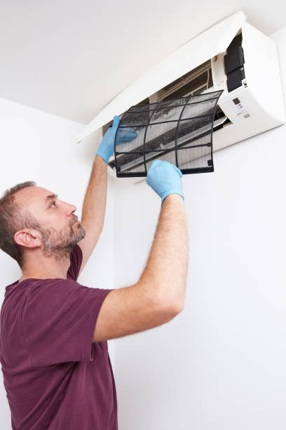 istock Man cleaning and maintaining air condition unit at home. 2191925128