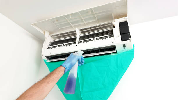istock Man cleaning and maintaining air condition unit at home. 2191925145