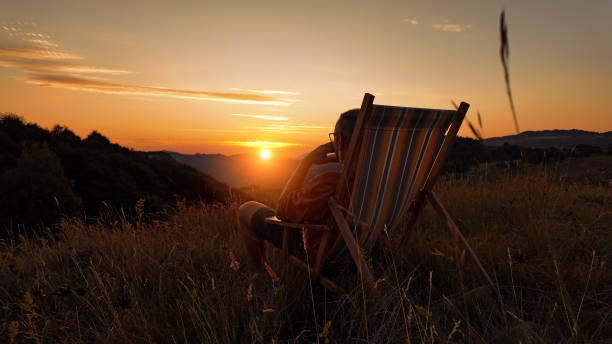 istock Silhouette of a man looking at the mountain sunset. 2191925195
