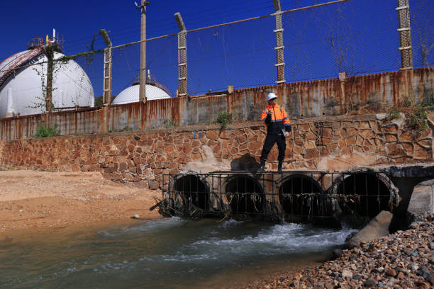 istock By walking around the Refinery Industrial zone, chemical engineers or environmentalists examine and collect wastewater samples. 2191926064