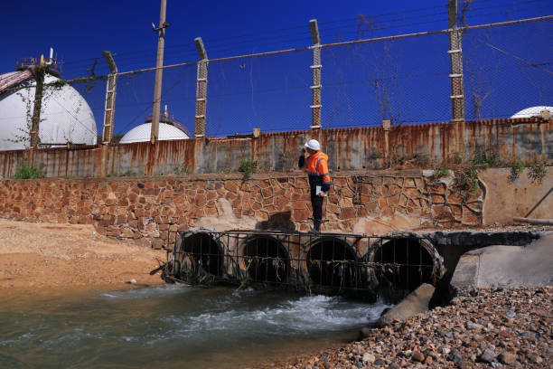 istock By walking around the Refinery Industrial zone, chemical engineers or environmentalists examine and collect wastewater samples. 2191926069