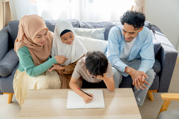 istock Asian little boy express serious during write puzzle game for playing with his older sister and joy with the family at home. 2191927752