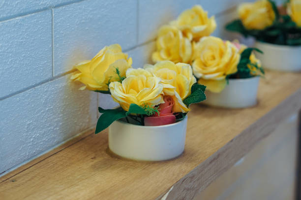 decorative flower pots on wooden shelves