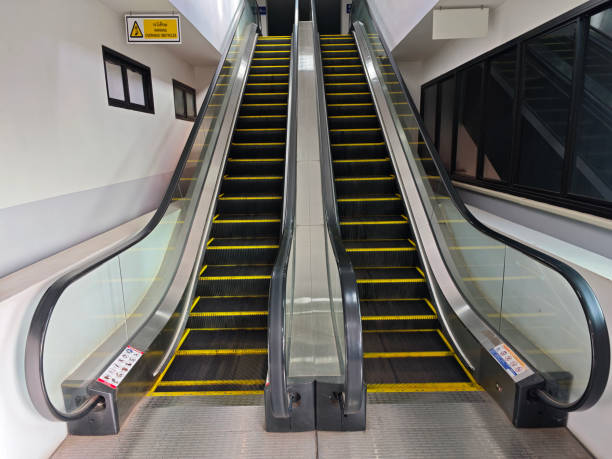 This image showcases a modern escalator inside an urban indoor space, highlighting safety features and sleek design elements with an emphasis on convenience and accessibility.