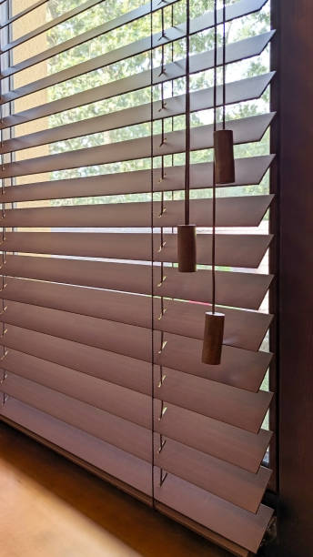istock Elegant wooden blinds with natural light. 2191930057