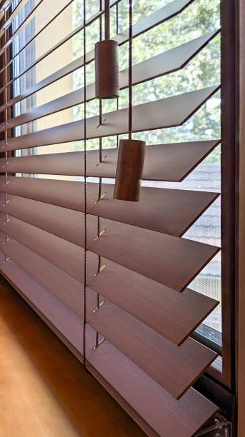 istock Elegant wooden blinds with natural light. 2191931671