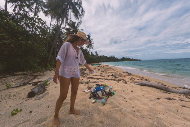 istock Woman Cleaning Beach on Tropical Island 2191932704