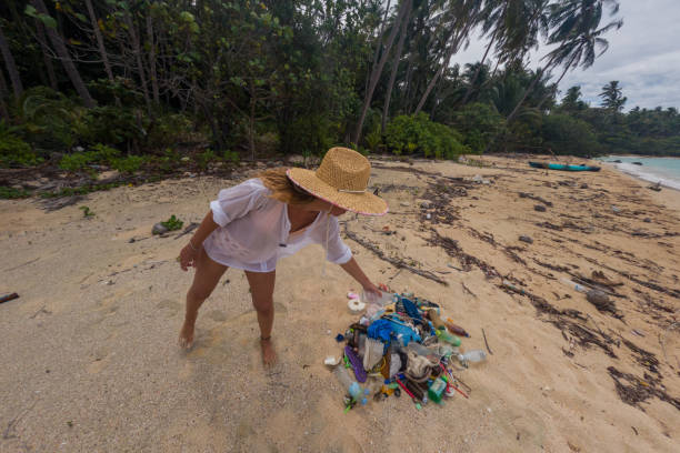 istock Woman Cleaning Beach on Tropical Island 2191932706