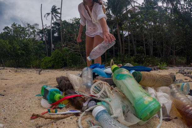 istock Woman Cleaning Beach on Tropical Island 2191932707
