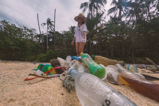 istock Woman Cleaning Beach on Tropical Island 2191932716