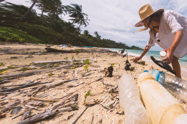 istock Woman Collecting Plastic Waste on Beach 2191932753