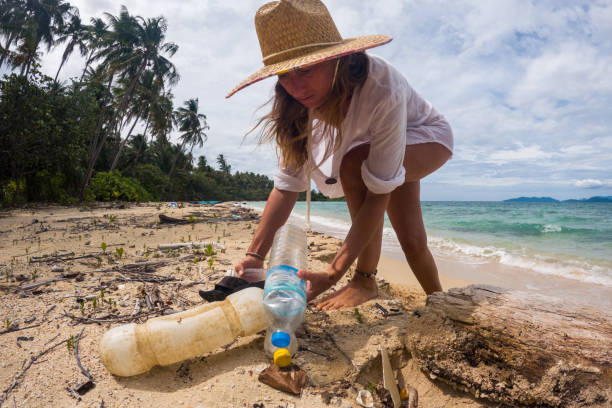 istock Woman Collecting Plastic Waste on Beach 2191932784