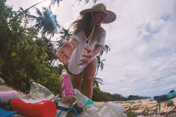 istock Woman Collecting Plastic Waste on Tropical Beach 2191932818