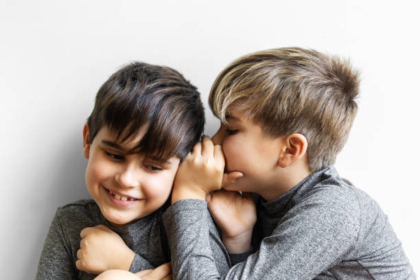 istock Brothers sharing a funny secret. 2191933348