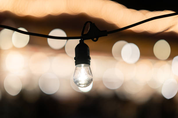 istock Light bulb hanging with bokeh effect in the background at night 2191936104