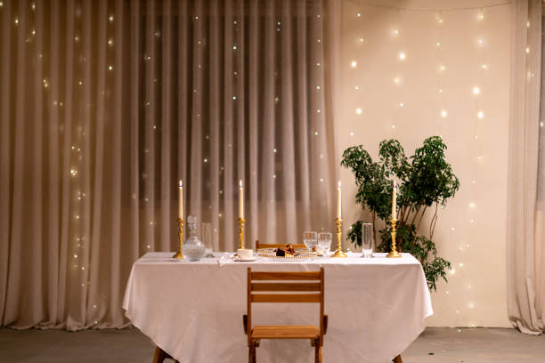 istock Romantic dinner table setup with candles and fairy lights 2191936140