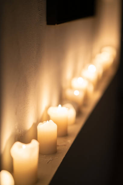 Several lit candles create a warm, inviting atmosphere in a dimly lit space