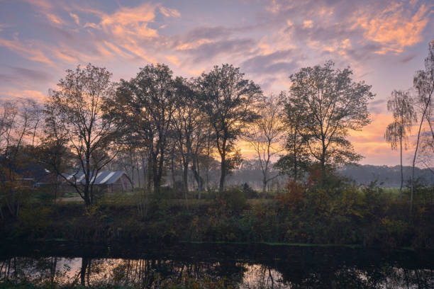 istock Serene Drenthe landscape with trees, water reflection, and sunset sky 2191936436