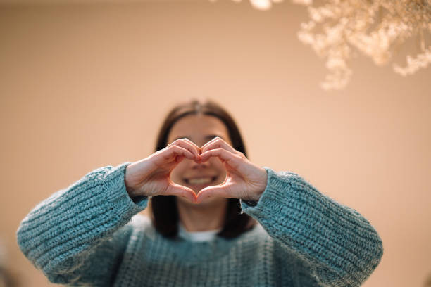 istock Young woman making heart shape with her hands 2191936495