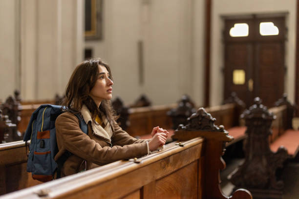 istock Young woman contemplating in cathedral 2191938624