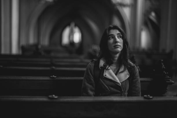 istock Young woman contemplating in cathedral 2191939137