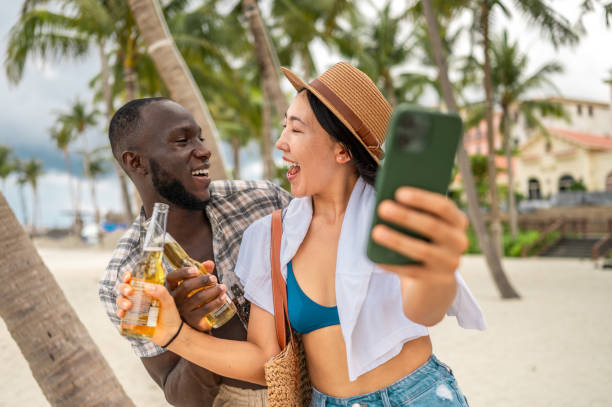 istock Beach Selfie with Happy Interracial Couple Enjoying Drinks 2191943614