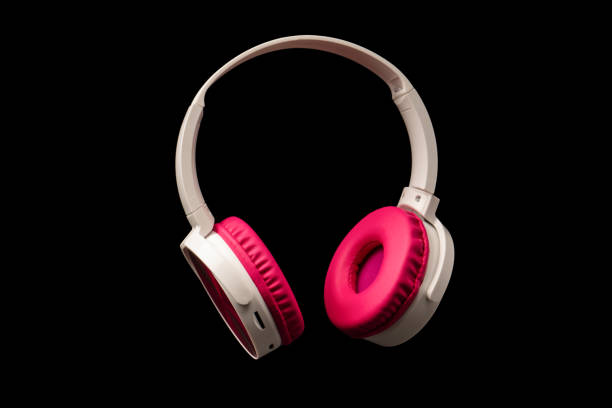 istock Pink and white headphones isolated on a black background. 2191943734