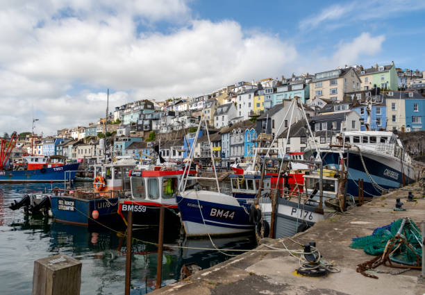 Brixham, Devon, UK - June 27 2024. The harbour and waterfront of Brixham on the Devon coast. Captured on a bright and sunny summer day