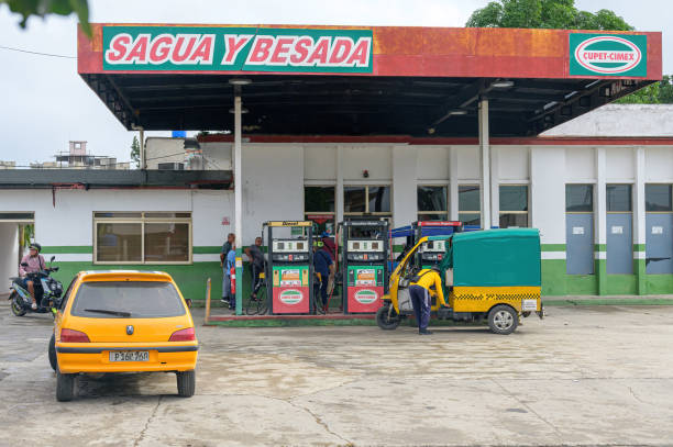 Santa Clara, Cuba - December 20, 2024: People and vehicles in a Cupet-Cimex gas station in the Sagua Road.