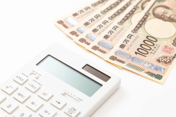Calculator and 10,000 yen bills on white background.