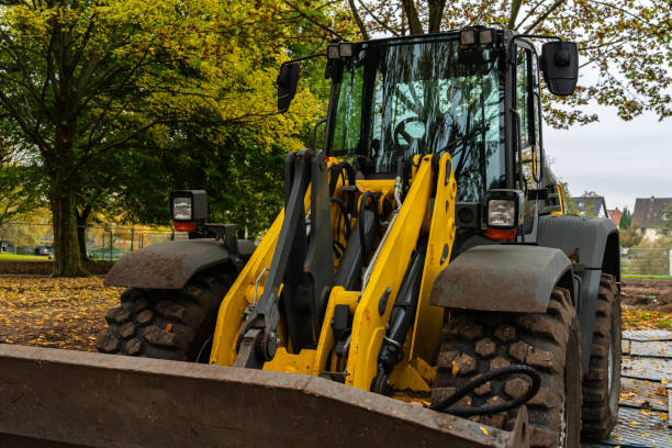 istock A large yellow and black loader is clearing fallen leaves in a park 2191954214