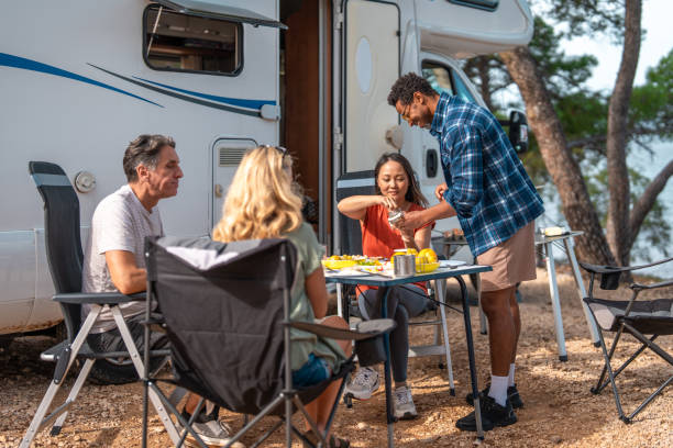 istock Diverse Couples Share Morning Breakfast Outside Their Seaside Motor Home Camp 2191960789