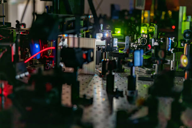 Experiment with laser device in optical laboratory. Experiment in optic lab with laser device. Experiment in optic lab with laser device.
