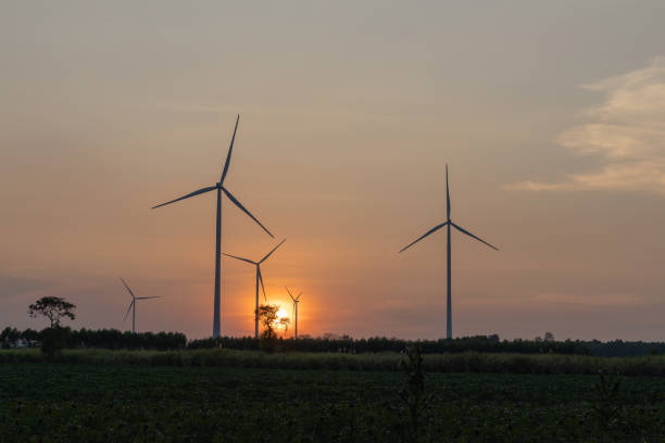 istock wind turbines stand majestically against a twilight sky, generating renewable energy amidst lush green fields 2191966526