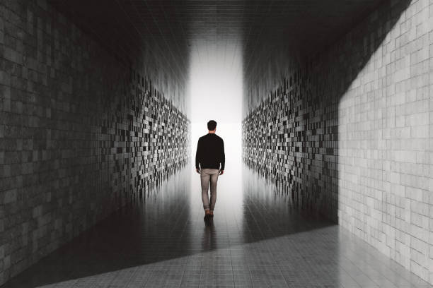 istock Young man walking in empty futuristic corridor 2191969549