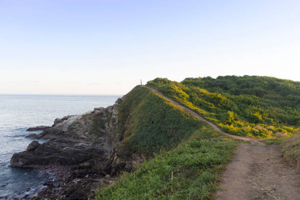 istock Tourist walking on a clifftop path overlooking the ocean in mexico,punta cometa 2191972220